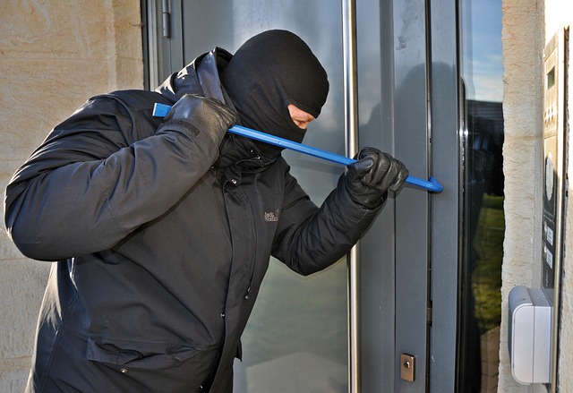 A burglar trying to forcefully enter a home.