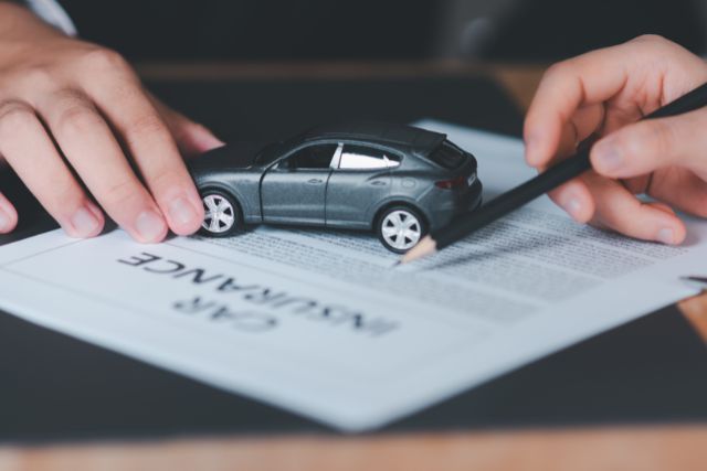 Reading a car insurance contract thoroughly.