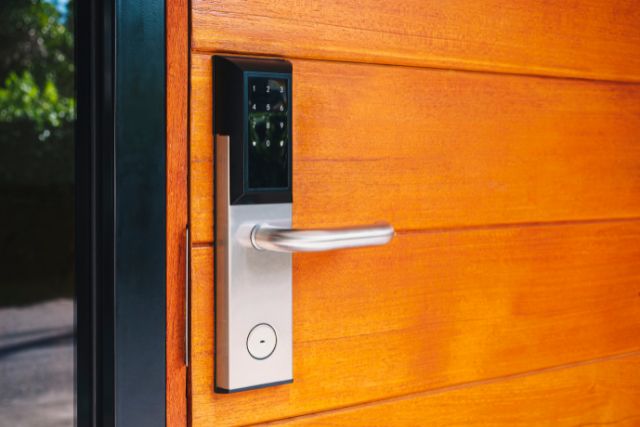 A modern digital door lock installed in a home front door.