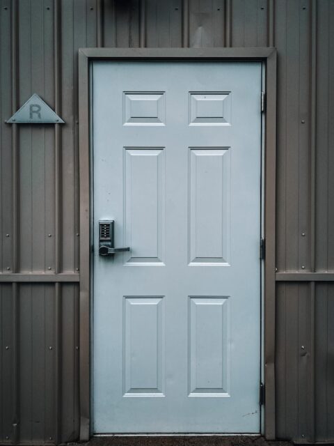 A white door with modern electronic lock.