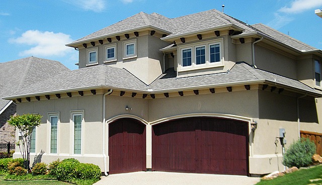 A beautiful home with a brown garage doors.