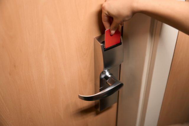 A person accessing a door using a key card.