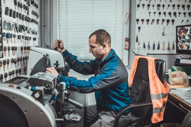 An expert locksmith doing key cutting.