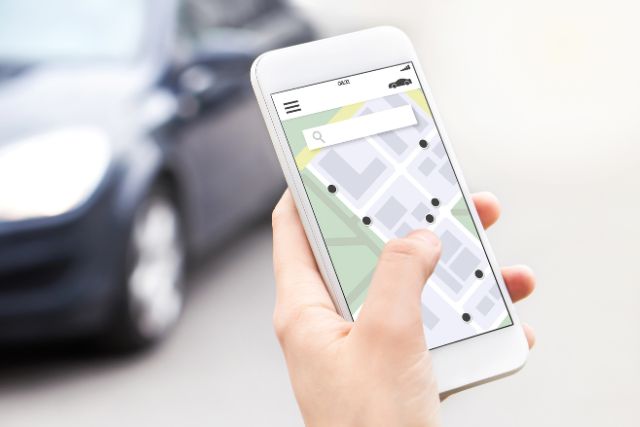 Booking a car via ride sharing app.