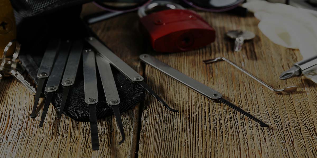 Locksmith tools scattered across bench.