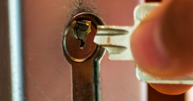 Close up image of a key being removed from a lock with half of the broken key still in the keyhole.