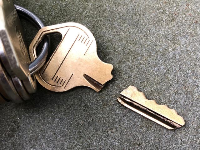 Broken house key that has been removed from lock.