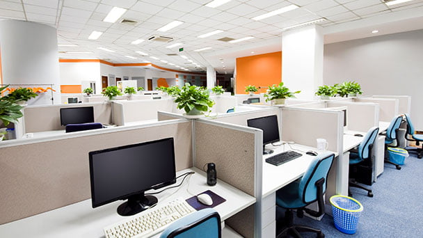 Office floor with desks, computers and office equipment.