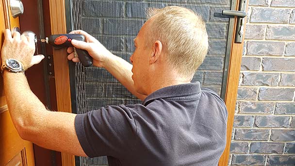 Ben working on a front door lock