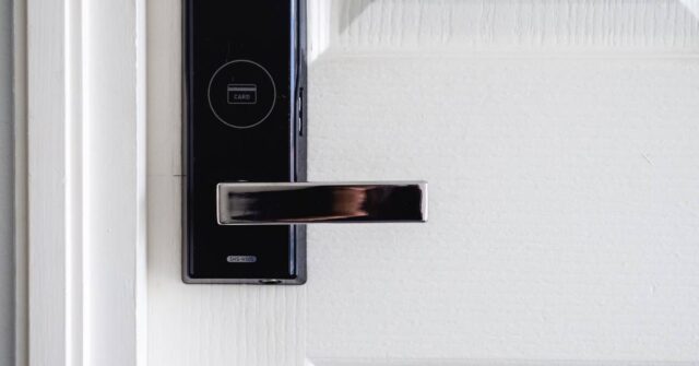 A white door with a smart digital lock installed.